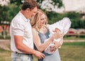 Portrait of a happy married couple with their newborn baby. Royalty Free Stock Photo