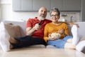 Happy Married Senior Couple Watching Tv And Eating Popcorn At Home Royalty Free Stock Photo