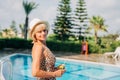 Portrait of happy mature adult woman near the pool and looking at camera. Beautiful smiling caucasian senior woman in Royalty Free Stock Photo