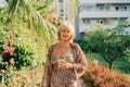 Portrait of happy mature adult woman relaxing and walking in tropical resort while looking at camera. Beautiful elegant Royalty Free Stock Photo