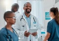 Portrait of a happy mature african american male doctor working on a digital tablet while working at a hospital with Royalty Free Stock Photo