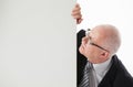 Portrait of a happy mature businessman holding empty white board Royalty Free Stock Photo