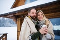 Portrait of happy mature couple in love enjoying holiday in mountain hut, standing outdoors. Royalty Free Stock Photo