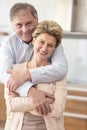 Portrait happy mature couple standing at home Royalty Free Stock Photo