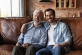 Portrait of happy mature father with grownup son hugging Royalty Free Stock Photo