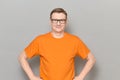Portrait of happy mature man with glasses, wearing orange T-shirt Royalty Free Stock Photo