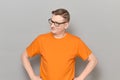 Portrait of happy mature man with glasses, wearing orange T-shirt Royalty Free Stock Photo