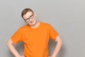 Portrait of happy mature man with glasses, wearing orange T-shirt Royalty Free Stock Photo