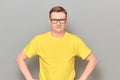 Portrait of happy mature man with glasses, wearing yellow T-shirt Royalty Free Stock Photo
