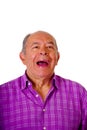 Portrait of a happy mature man laughting very loud and wearing a purple square t-shirt in a white background Royalty Free Stock Photo