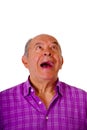 Portrait of a happy mature man laughting very loud and wearing a purple square t-shirt in a white background Royalty Free Stock Photo