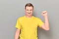 Portrait of happy mature man raising clenched fist up and smiling Royalty Free Stock Photo