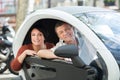 Couple standing near twizy electric