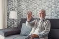 Portrait of happy mature 80s man sit on couch at home look at camera posing relaxing on weekend, smiling positive senior 70s Royalty Free Stock Photo