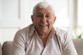 Portrait of smiling mature man relaxing at home Royalty Free Stock Photo