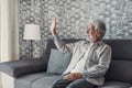 Portrait of happy mature 80s man sit on couch at home look at window posing relaxing on weekend, smiling positive senior 70s Royalty Free Stock Photo