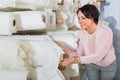 Portrait of happy mature woman with cloth rolls Royalty Free Stock Photo