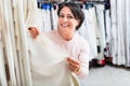 Portrait of happy mature woman with cloth specimens Royalty Free Stock Photo