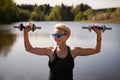 Portrait happy mature woman exercises with dumbbells outdoors, fitness training amidst beauty of nature, physical well Royalty Free Stock Photo