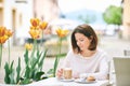 Portrait of happy mature woman having coffee with croissant Royalty Free Stock Photo