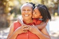 Portrait happy mature woman and her granddaughter spending quality time together in the park during summer. Cute little Royalty Free Stock Photo