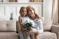 Portrait of happy mature woman holding on lap little princess. Royalty Free Stock Photo