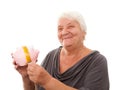 Portrait of a happy mature woman holding piggy bank isolated against white Royalty Free Stock Photo