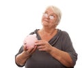 Portrait of a happy mature woman holding piggy bank isolated against white Royalty Free Stock Photo