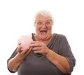 Portrait of a happy mature woman holding piggy bank isolated against white Royalty Free Stock Photo