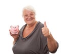 Portrait of a happy mature woman holding piggy bank isolated against white Royalty Free Stock Photo