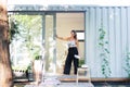 Portrait of mature woman with pallete painting in container house.