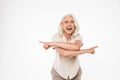 Portrait of a happy mature woman pointing fingers Royalty Free Stock Photo