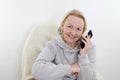 Portrait of a happy mature woman using cellphone while man using laptop in bed at home Royalty Free Stock Photo