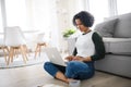 Portrait of happy mature woman working on laptop indoors, home office concept. Royalty Free Stock Photo