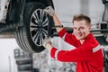 portrait happy mechanic garage staff worker enjoy car service. tire replace in garage auto workshop Royalty Free Stock Photo