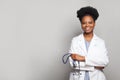 Portrait of happy medical intern doctor standing on white background