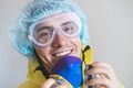 Portrait of a happy medical worker puts off protective gear after a shift. Concept of covid-19 epidemic, healthcare personell and Royalty Free Stock Photo