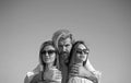 Portrait of happy man between two girls standing on sky background on summer vacation. Royalty Free Stock Photo