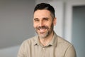 Portrait of happy middle aged businessman working in office, posing and smiling at camera, copy space Royalty Free Stock Photo