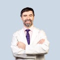 Portrait of happy middle-aged dentist on a pale background, wear Royalty Free Stock Photo