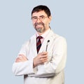 Portrait of happy middle-aged dentist on a pale background, wear