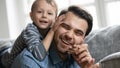 Portrait of happy millennial father resting on couch Royalty Free Stock Photo