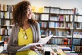 Portrait of happy mixed race college woman student at campus library Royalty Free Stock Photo