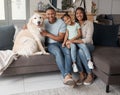 Portrait of a happy mixed race family of three relaxing on the sofa with their dog. Loving black family being Royalty Free Stock Photo