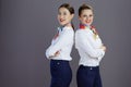 Portrait of happy modern female air hostesses isolated on grey Royalty Free Stock Photo