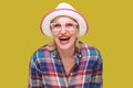 Portrait of happy modern stylish mature woman in casual style with hat and eyeglasses standing and looking at camera with Royalty Free Stock Photo