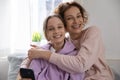 Portrait of happy mom and teen daughter hugging at home Royalty Free Stock Photo