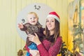 Portrait of happy mother and adorable baby celebrate Christmas. Royalty Free Stock Photo