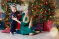 Portrait of happy mother and adorable baby celebrate Christmas. New Year`s holidays. Toddler with mom in the festively decorated Royalty Free Stock Photo