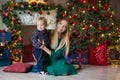 Portrait of happy mother and adorable baby celebrate Christmas. New Year`s holidays. Toddler with mom in the festively decorated Royalty Free Stock Photo